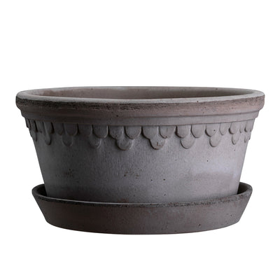 Wide grey ceramic planter with decorative pattern and matching saucer on a white background