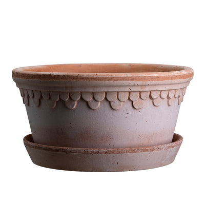 Wide terracotta ceramic planter with decorative pattern and matching saucer on a white background