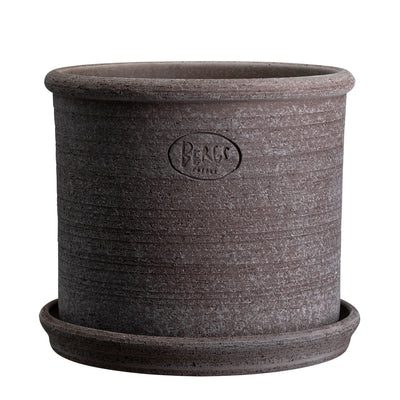 Cylindrical grey ceramic pot with an embossed Bergs Potter brand logo and matching saucer on a white background