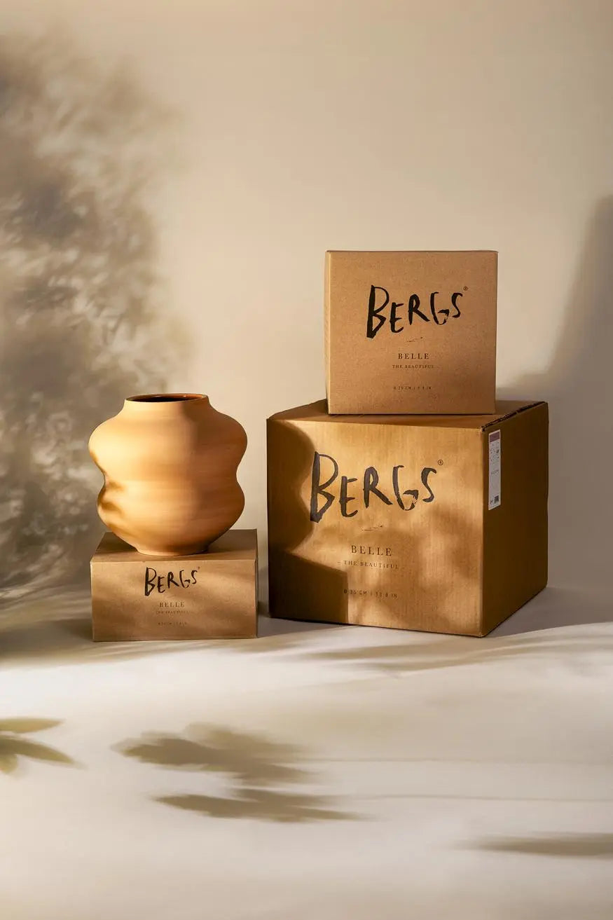 Terra cotta Bergs Potter vase and boxes with 'Bergs' branding on a neutral background
