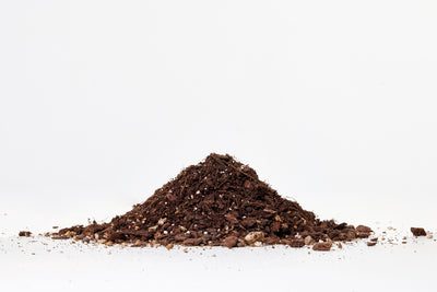 Pile of dark brown compost on a white background
